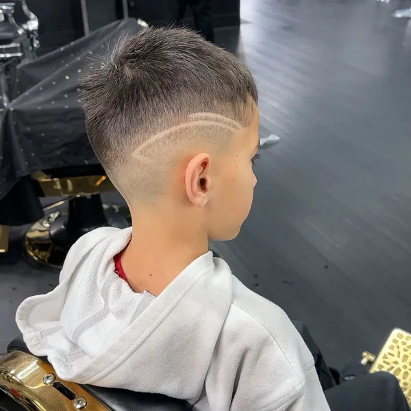 Kids haircut with a skin fade and double-line design