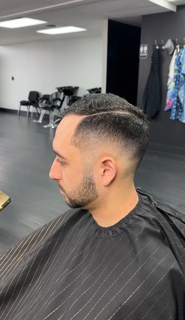 Classic side part with a mid fade and full beard blend